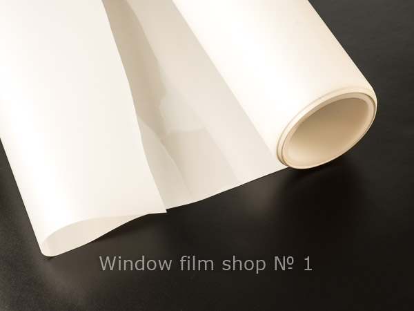 Roll of white matte frosted window film partly unrolled