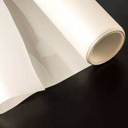Roll of white matte window film partly unrolled