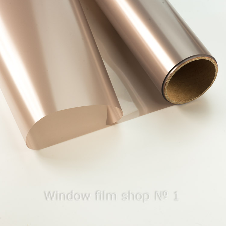 Roll of bronze matte window film, partly unrolled